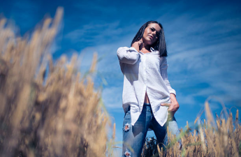 Stylish woman wearing an oversized shirt with distressed jeans